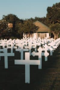white cross on green grass field during daytime