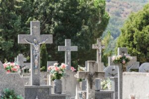 a bunch of headstones with flowers in them
